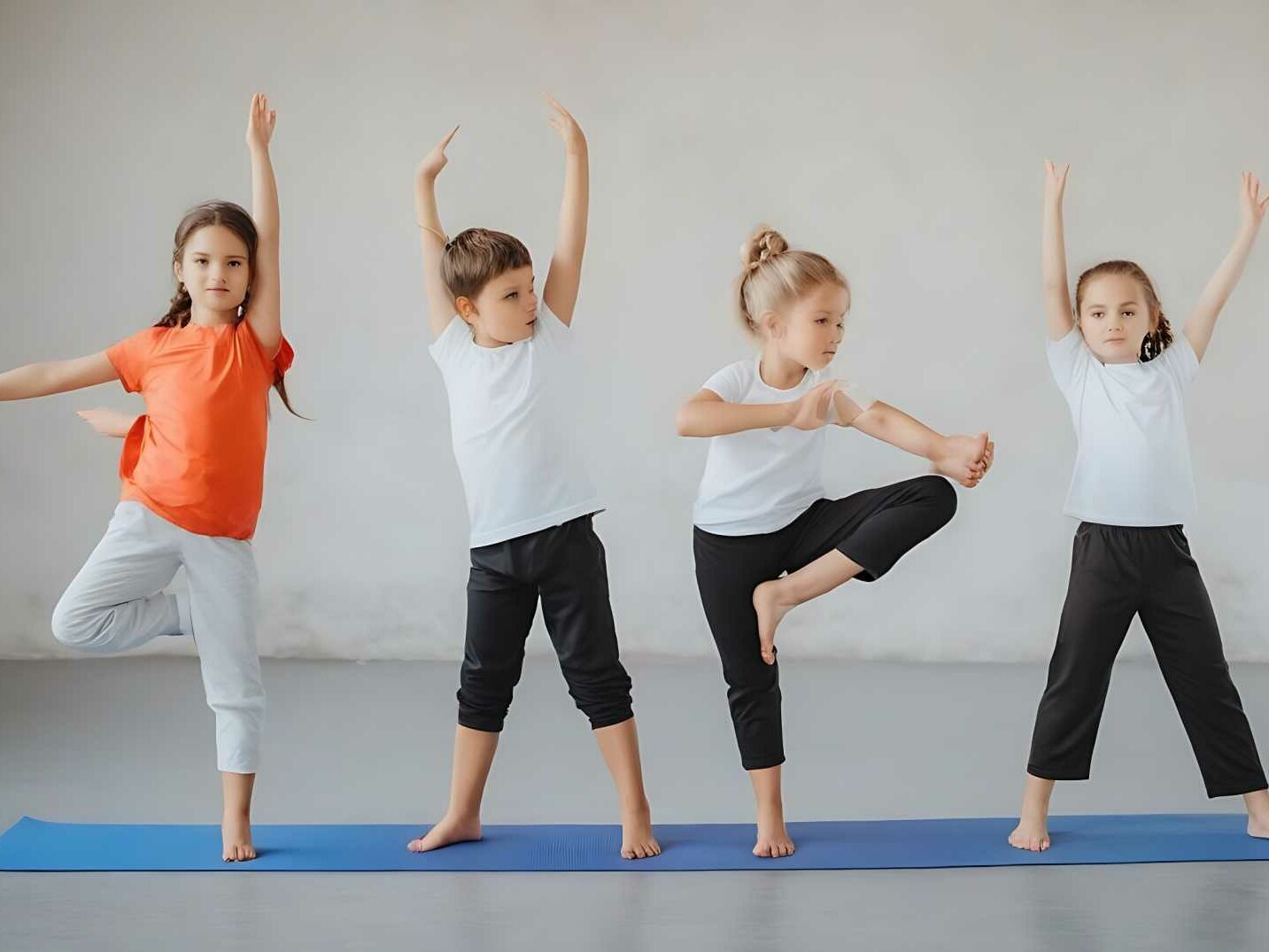 Smiling children engaging in playful yoga and martial arts activities